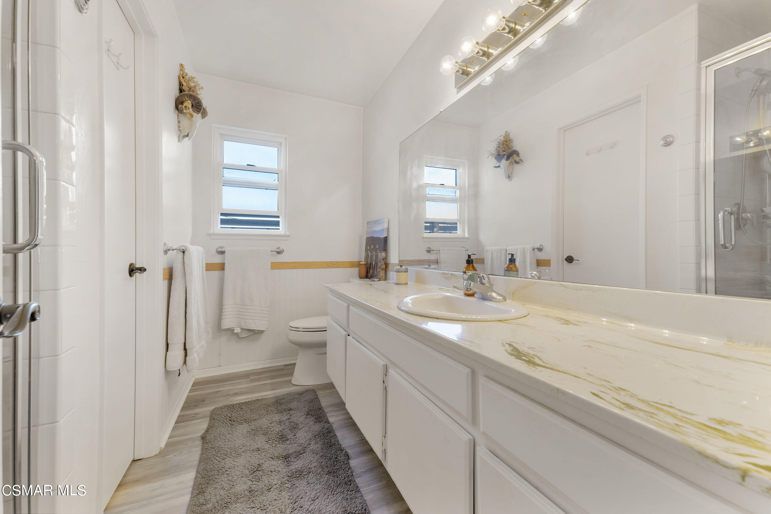 1065 Rambling Road Simi Valley, CA 93065 - Photo 12 of 54 a bathroom with a double vanity sink mirror and toilet