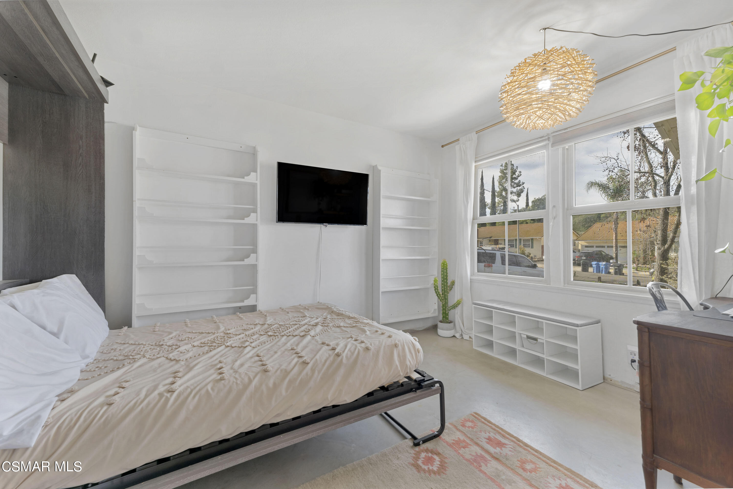 1065 Rambling Road Simi Valley, CA 93065 - Photo 14 of 54 a bedroom with a bed and a chandelier