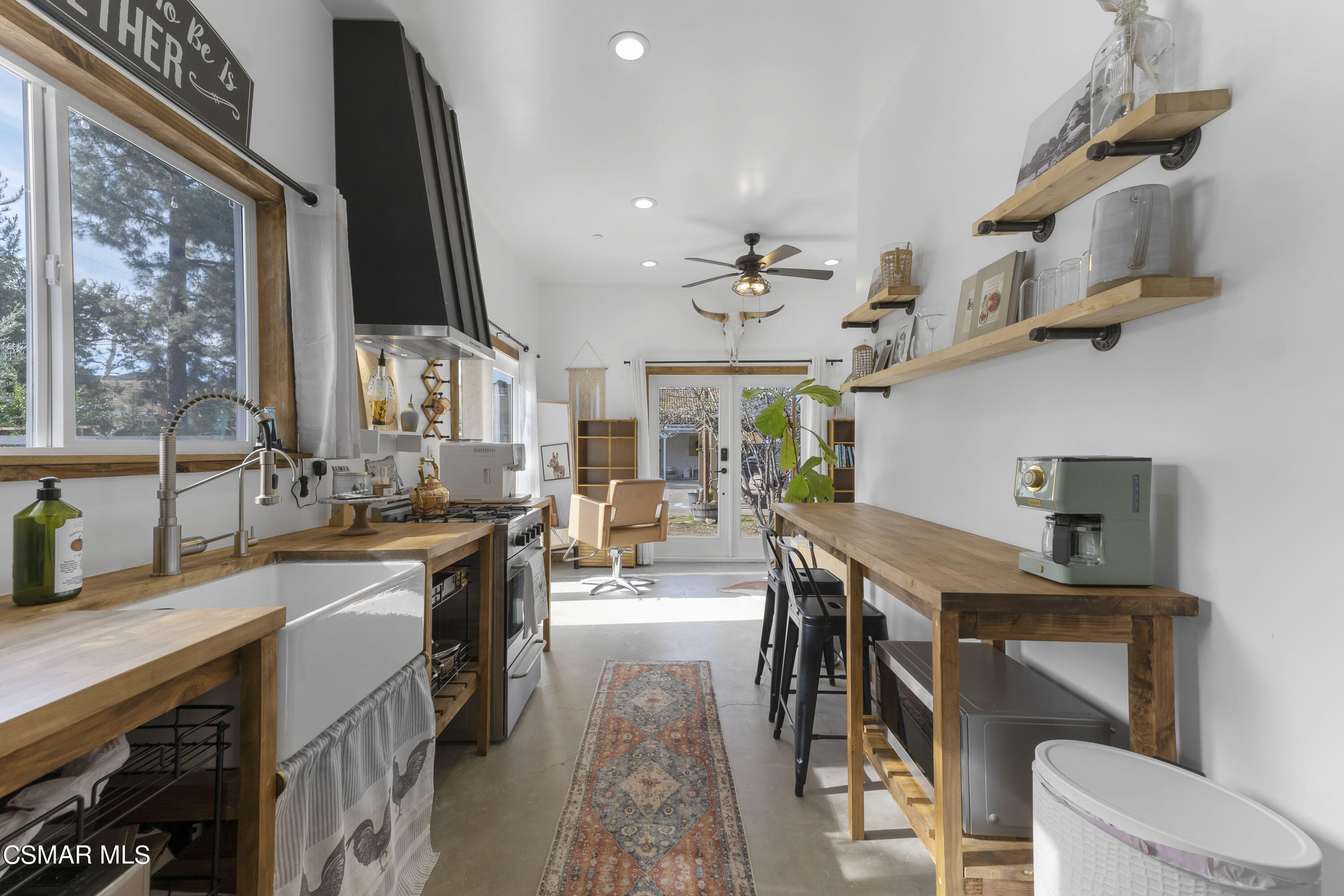 1065 Rambling Road Simi Valley, CA 93065 - Photo 26 of 54 a kitchen with stainless steel appliances granite countertop a sink a stove and a wooden floors