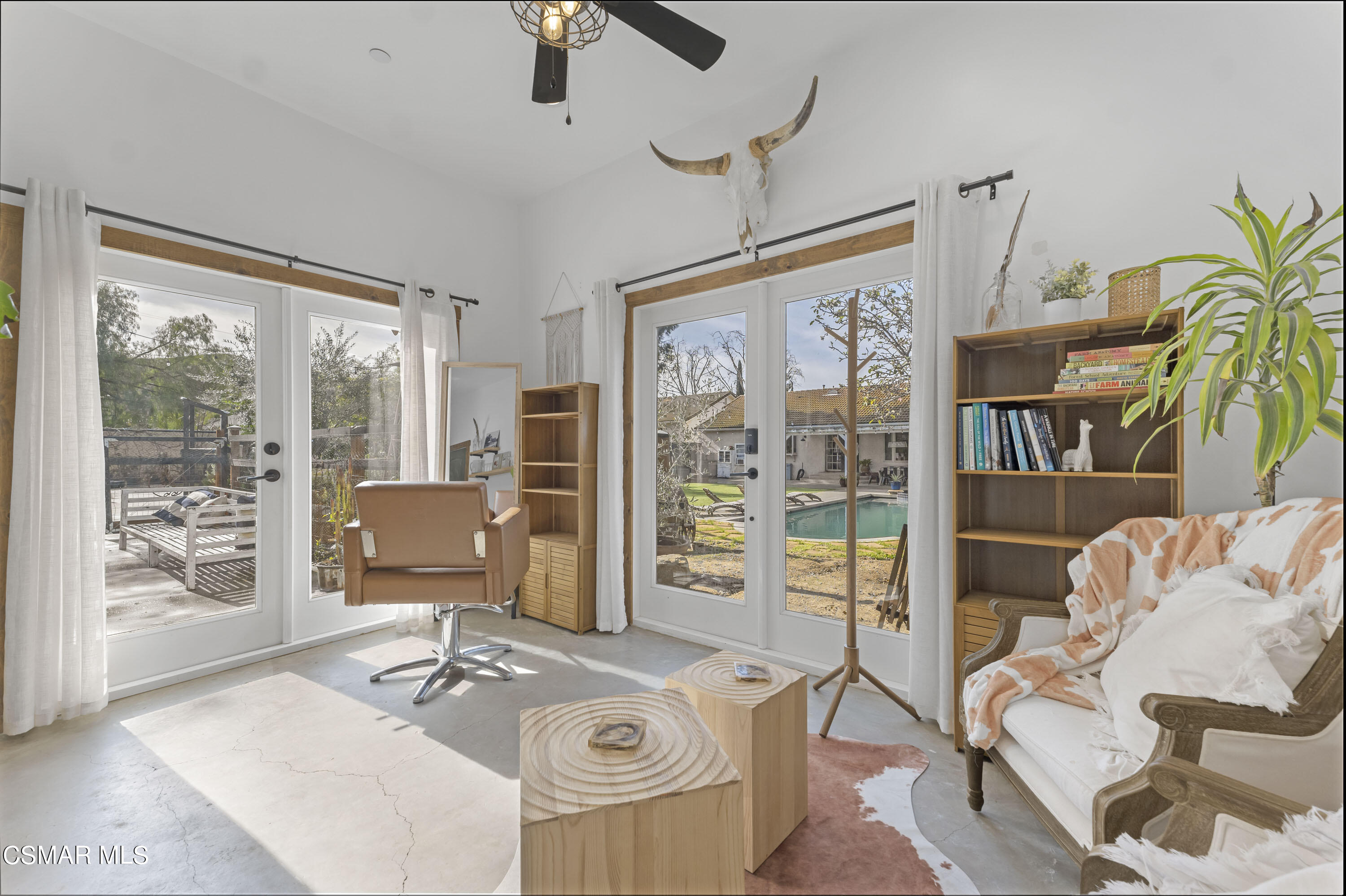 1065 Rambling Road Simi Valley, CA 93065 - Photo 28 of 54 a living room with furniture a flat screen tv and a floor to ceiling window