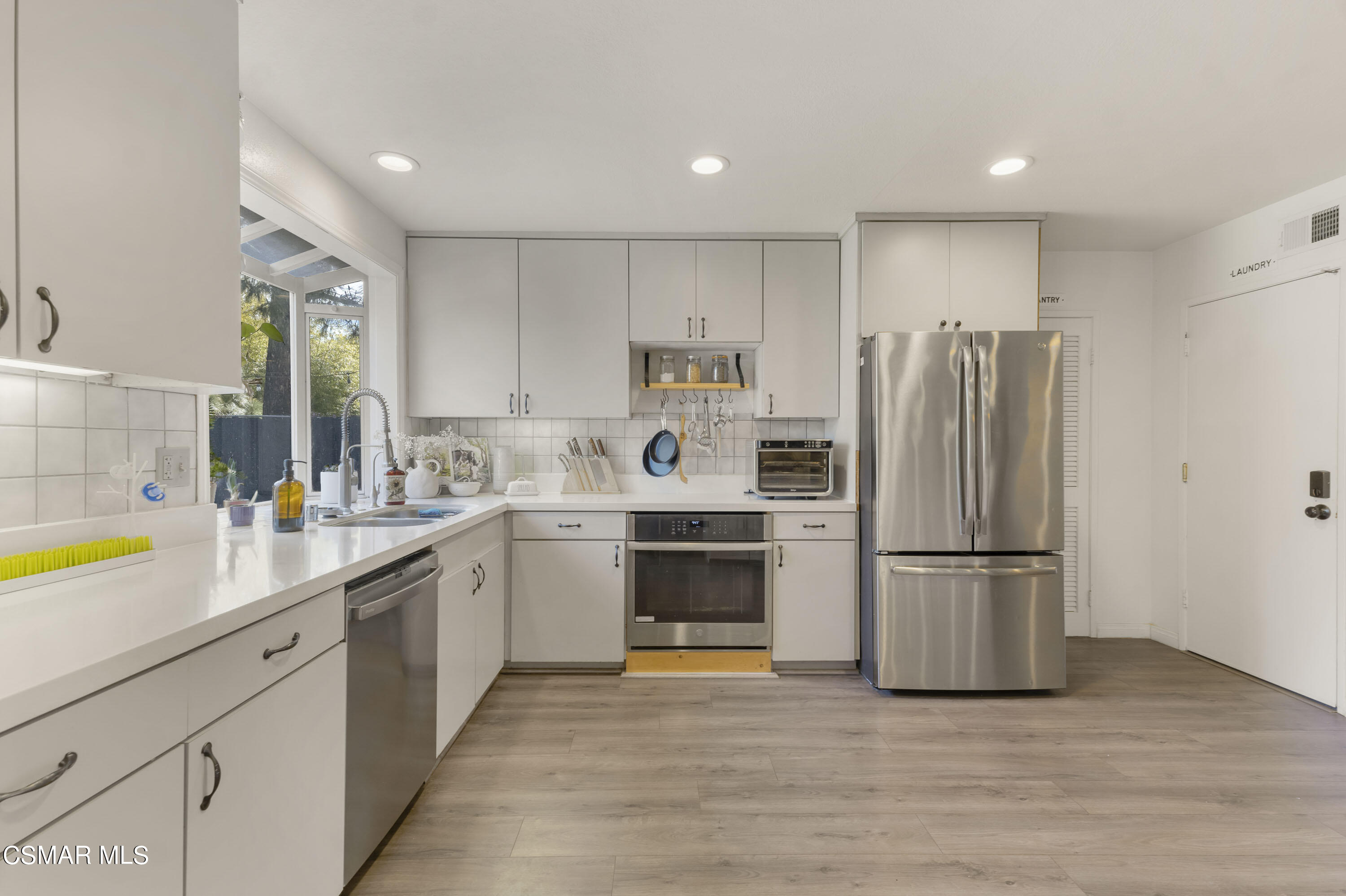 1065 Rambling Road Simi Valley, CA 93065 - Photo 47 of 54 a kitchen with a refrigerator and a sink