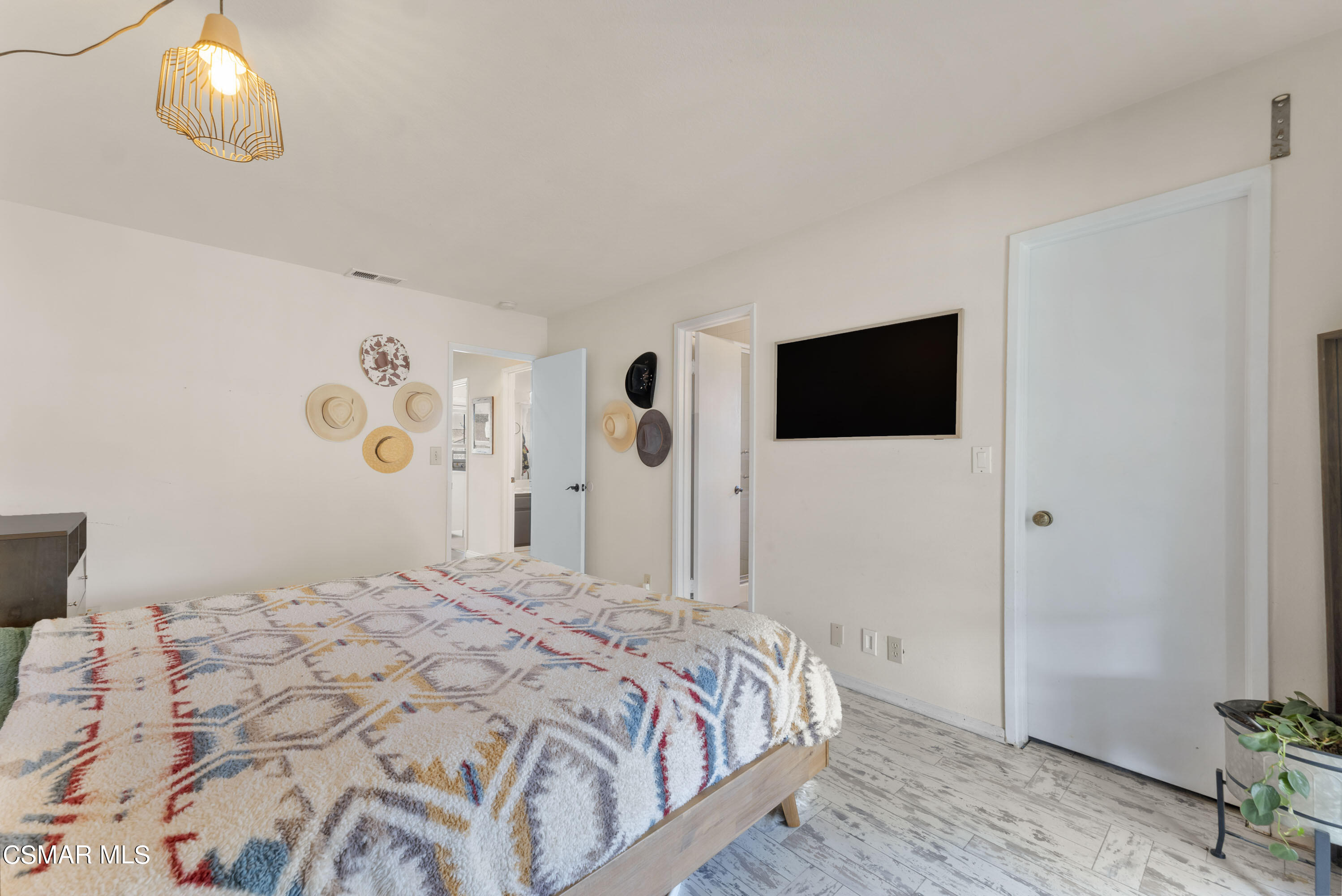 1065 Rambling Road Simi Valley, CA 93065 - Photo 9 of 54 a bedroom with a bed and a chandelier