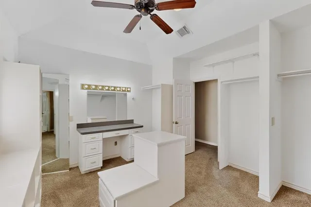 a bathroom with a granite countertop sink and mirror with bathtub