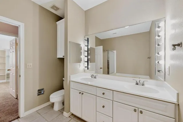 a living room with stainless steel appliances kitchen island a stove and a refrigerator