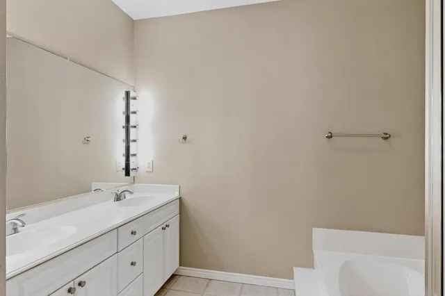 a bathroom with a sink double vanity and a toilet