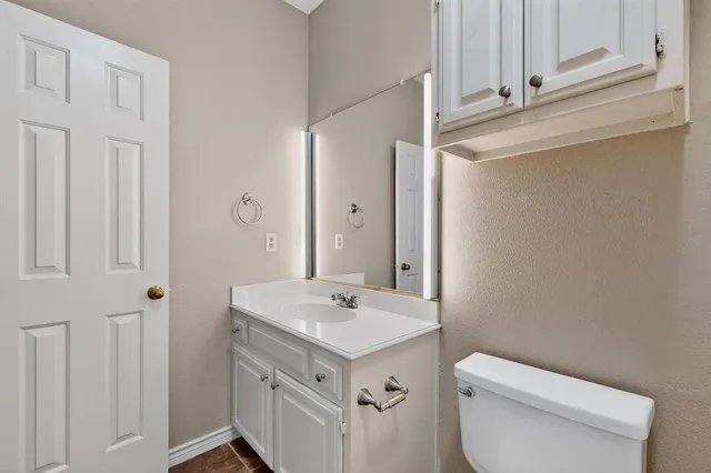 a bathroom with a sink toilet and vanity