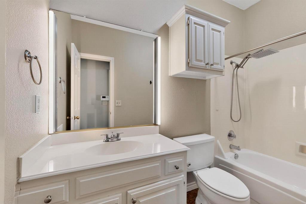 2104 Old McGarrah Road McKinney, TX 75072 - Photo 22 of 39 a bathroom with a sink a toilet and a mirror