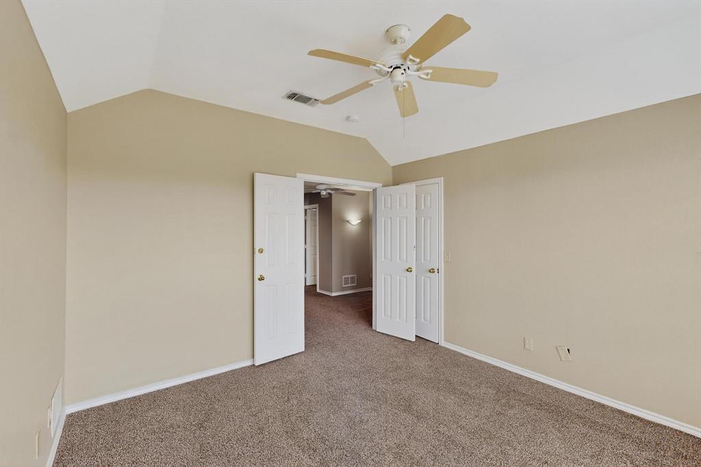 2104 Old McGarrah Road McKinney, TX 75072 - Photo 28 of 39 an empty room with a ceiling fan and a window
