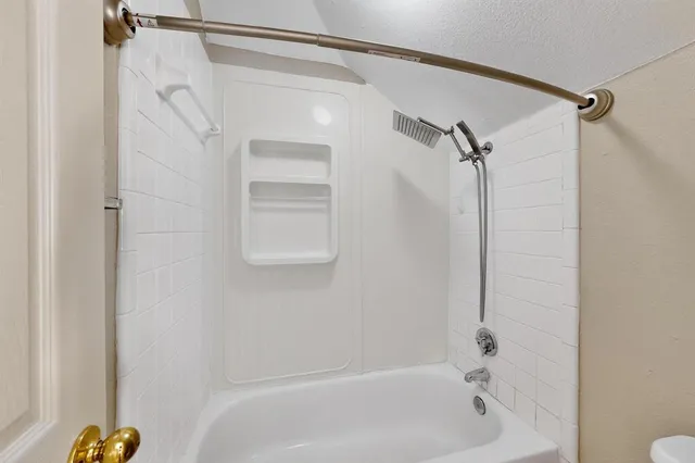 a bathroom with a shower and a shower