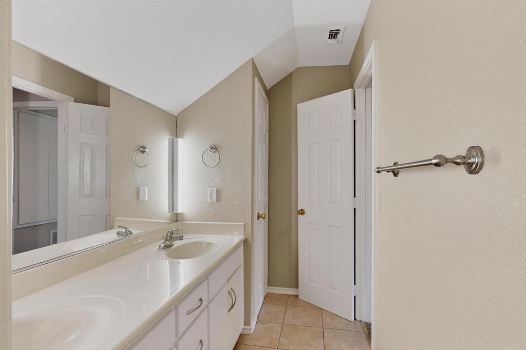 2104 Old McGarrah Road McKinney, TX 75072 - Photo 33 of 39 a bathroom with a double vanity sink and mirror