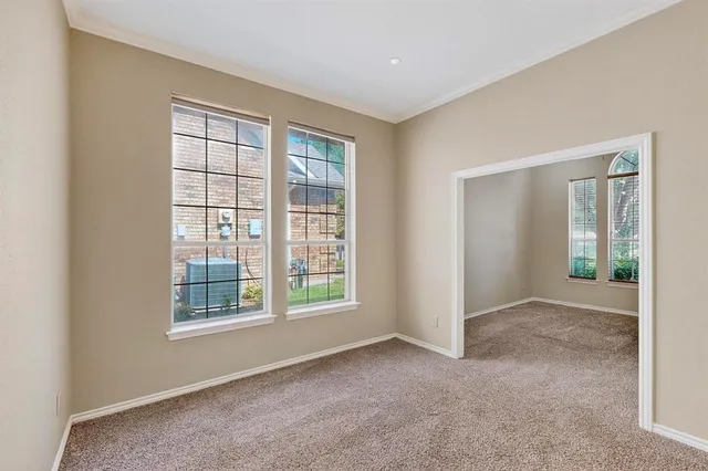 an empty room with windows and closet