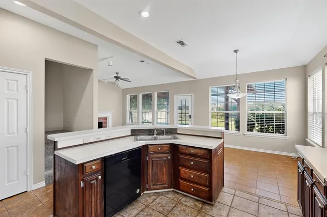 a kitchen with a stove a sink and a window