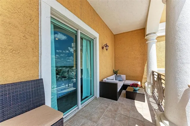 a living room with furniture gym equipment and large windows