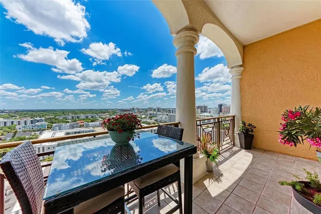 a living room with furniture potted plant and windows