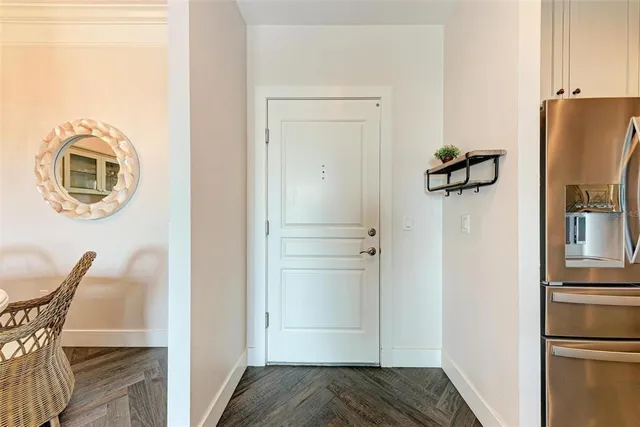 a view of kitchen with furniture and refrigerator