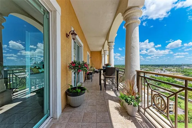 a view of a patio with chairs and potted plants