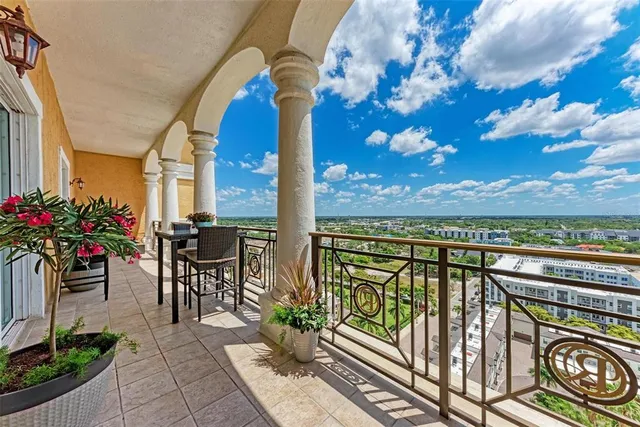 a view of a dining room with furniture wooden floor and chandelier
