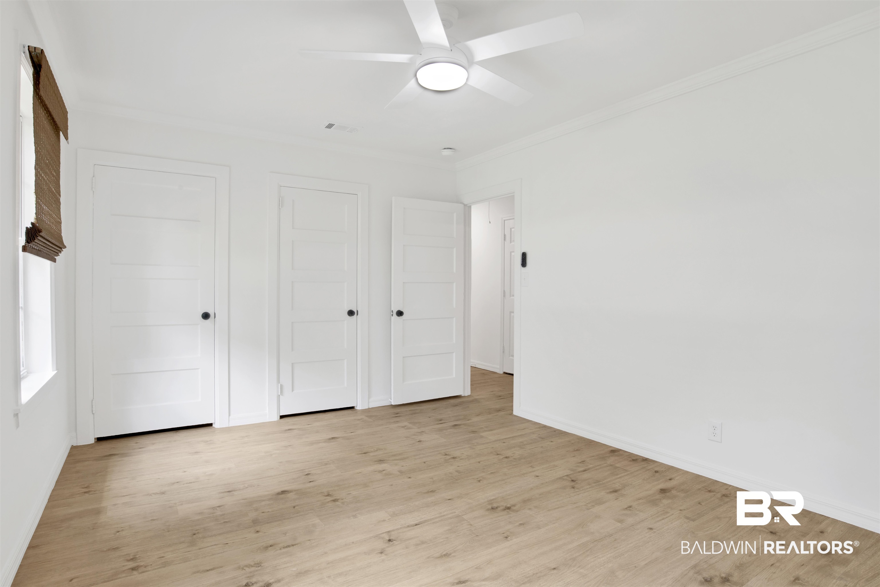 317 Lee Street Chickasaw, AL 36611 - Photo 20 of 40 Bedroom 2 room with two closets, crown molding, wood finished floors, and ceiling fan
