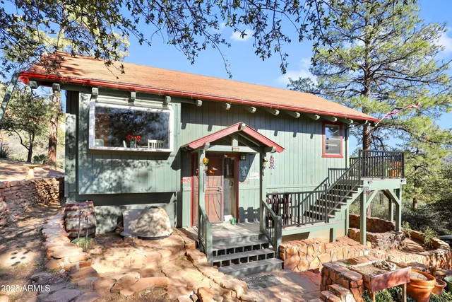 a view of a house with wooden deck and furniture