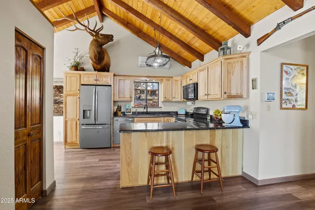 a kitchen with stainless steel appliances a refrigerator stove and microwave