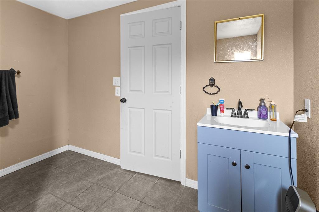 601 Southwest Quarry Circle Fort White, FL 32038 - Photo 18 of 21 a bathroom with a sink and a mirror