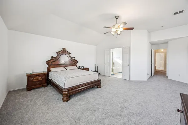 a bedroom with a bed and a ceiling fan
