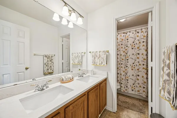 a bathroom with a double vanity sink mirror and double
