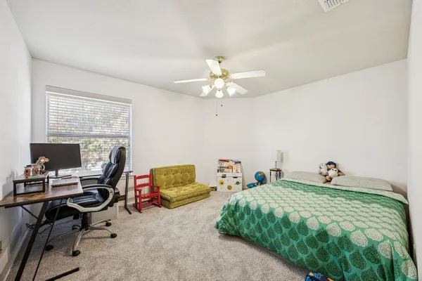 a bedroom with a bed gym equipment and a chandelier