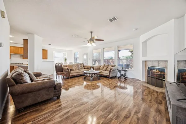 a living room with furniture fireplace and flat screen tv