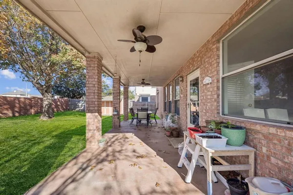 a view of a patio with a table and chairs