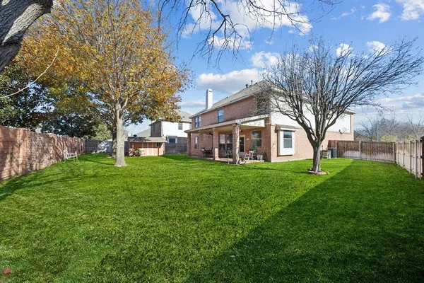 a view of a yard with a house in the background