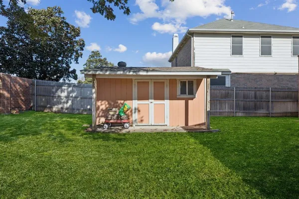 a front view of house with a garden