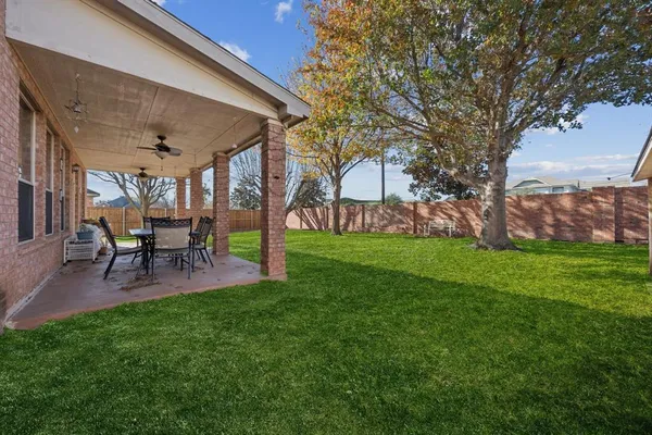a patio with garden and outdoor seating