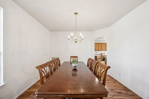 a dining room with furniture and chandelier