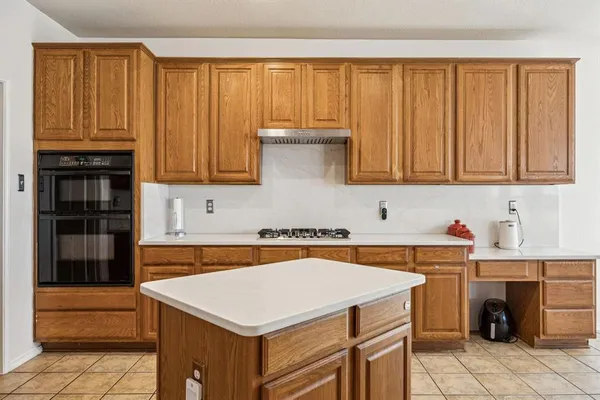 a kitchen with a stove and a refrigerator