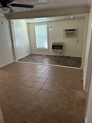 a view of a livingroom with wooden floor and a ceiling fan