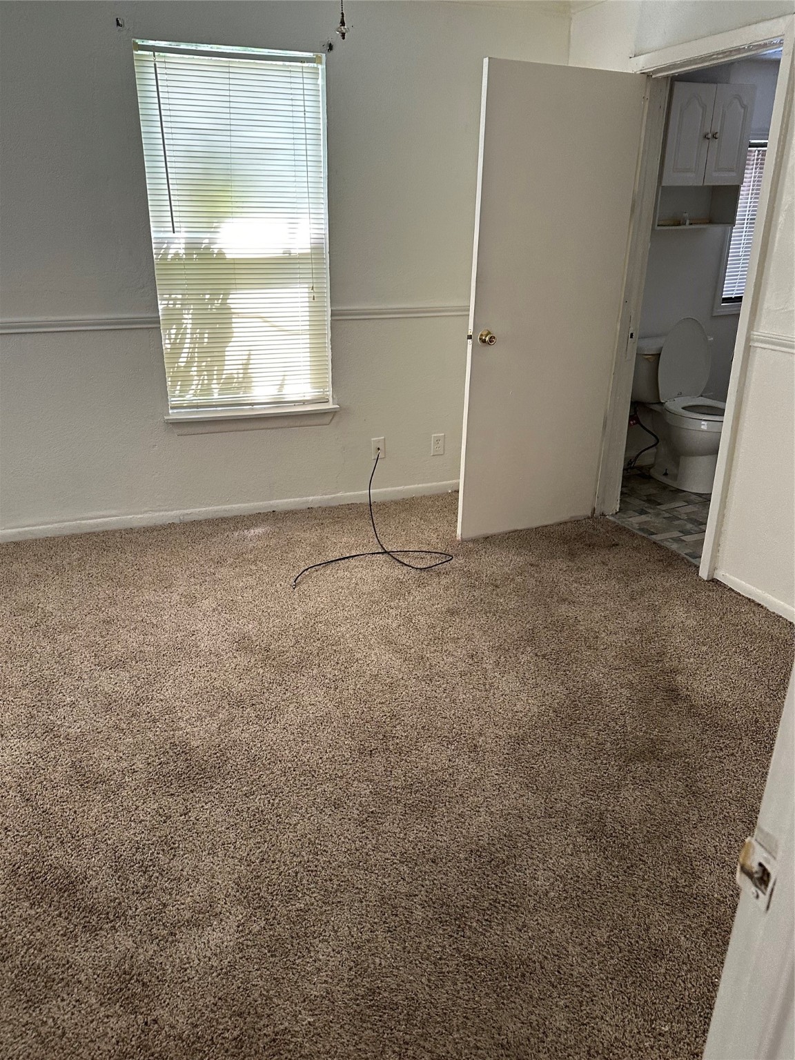 409 7th Street Huntsville, TX 77320 - Photo 16 of 17 a view of an empty room with a window