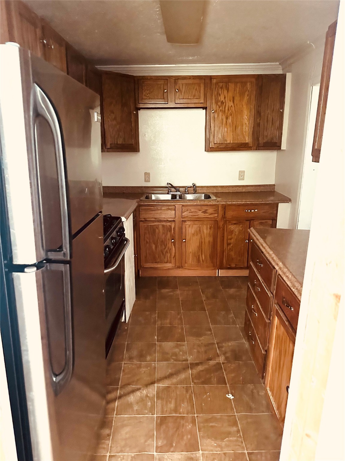 409 7th Street Huntsville, TX 77320 - Photo 7 of 17 a kitchen with stainless steel appliances a refrigerator and a stove