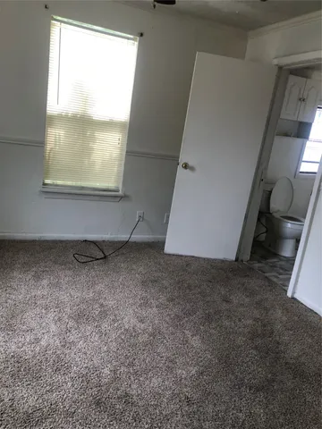 a view of a livingroom with wooden floor and window