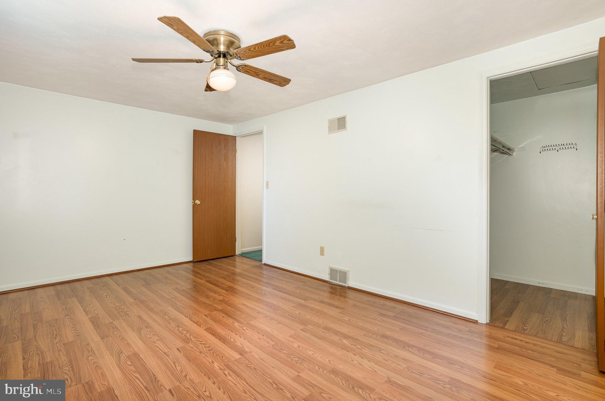 415 Weldon Drive York, PA 17404 - Photo 14 of 34 an empty room with wooden floor and a ceiling fan