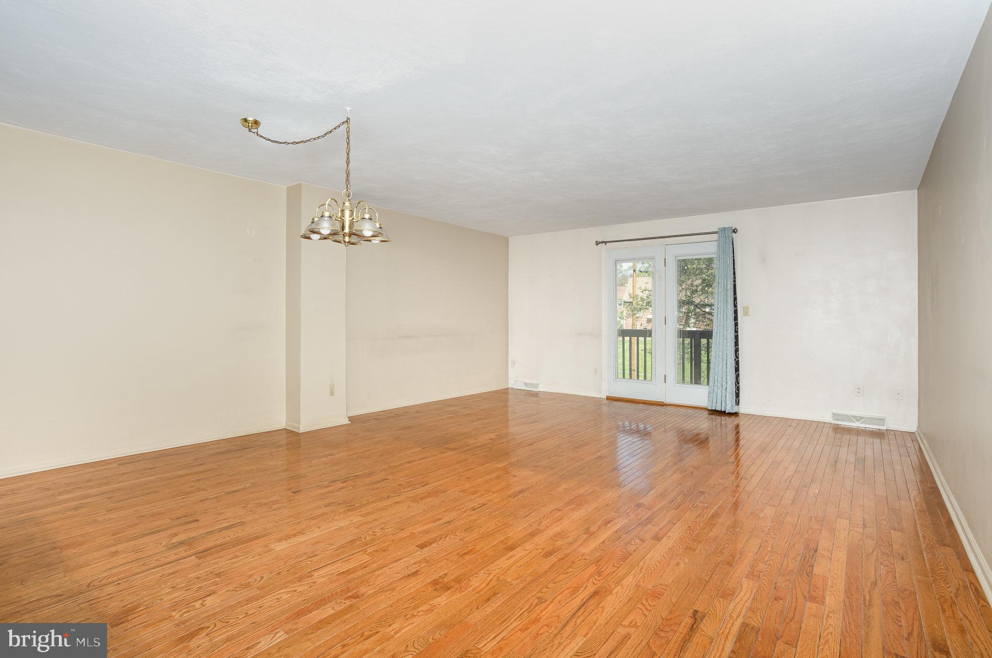415 Weldon Drive York, PA 17404 - Photo 4 of 34 a view of an empty room with wooden floor and a window