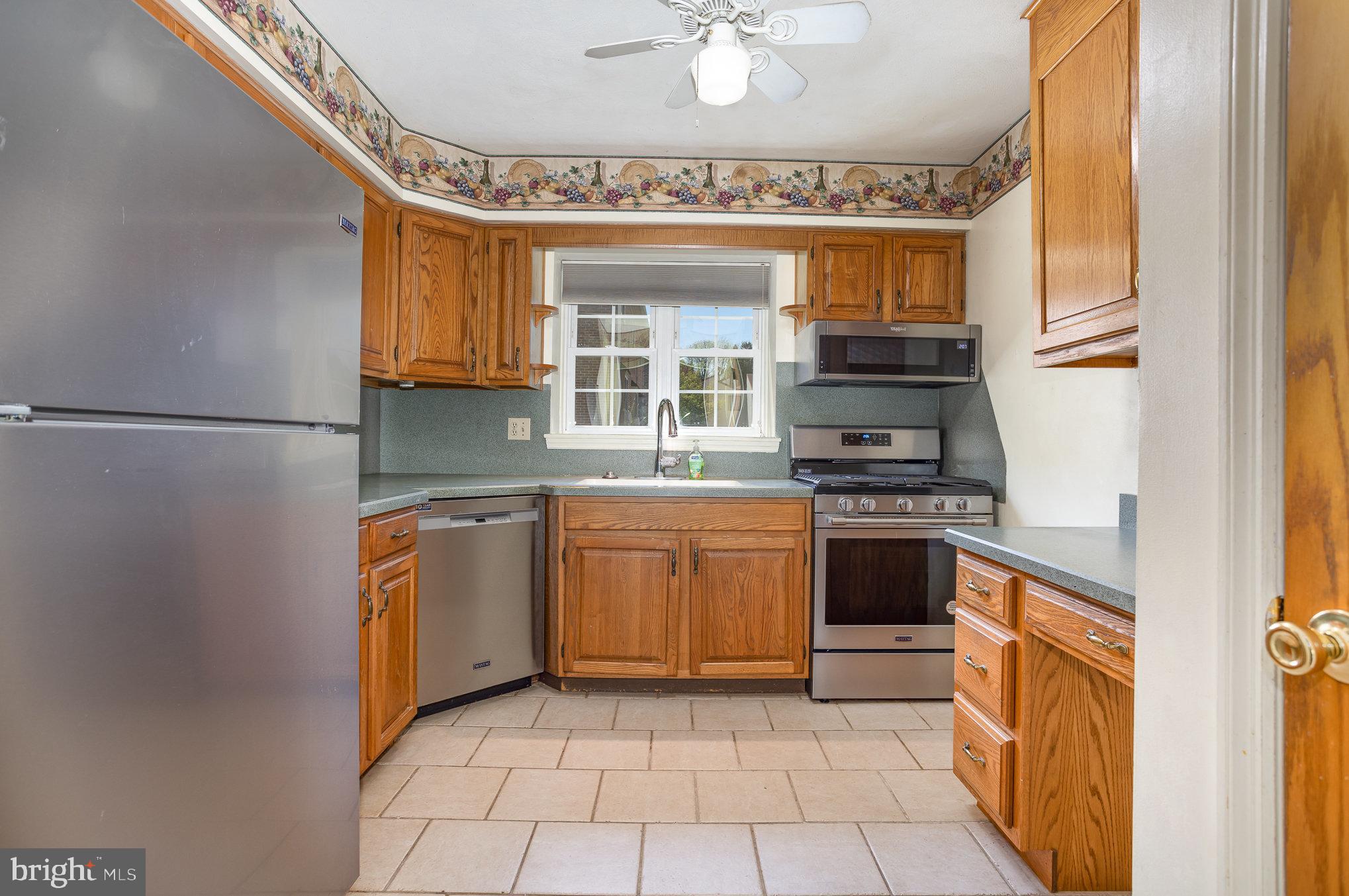 415 Weldon Drive York, PA 17404 - Photo 7 of 34 a kitchen with stainless steel appliances granite countertop a stove top oven a sink and a refrigerator