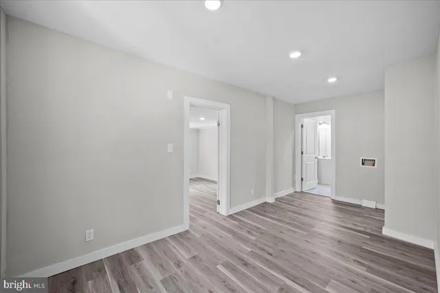 a view of an empty room with wooden floor
