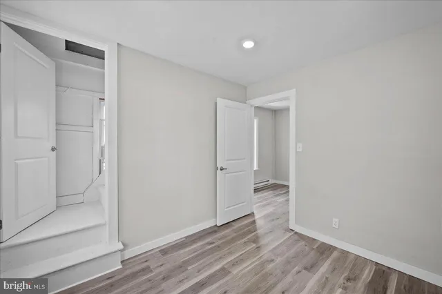 a view of an empty room and wooden floor