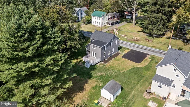 an aerial view of residential houses with outdoor space
