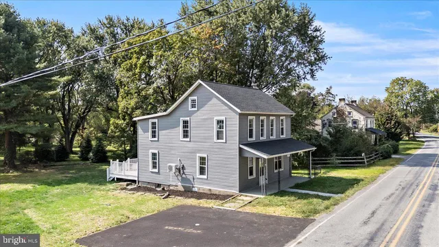 a view of a house with pool and chairs in a yard