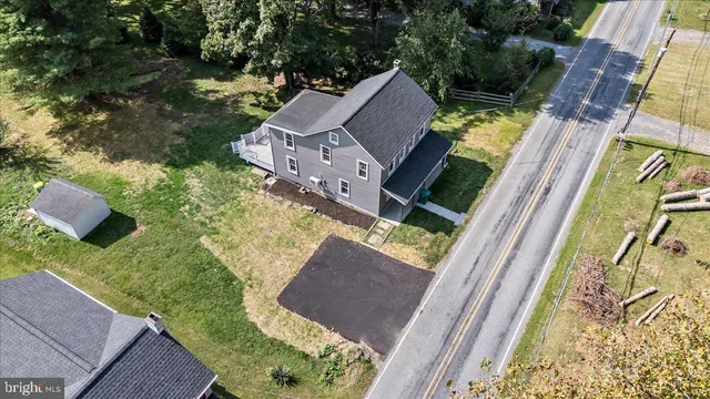 an aerial view of a house with a garden and swimming pool