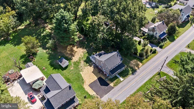 an aerial view of a house with a yard