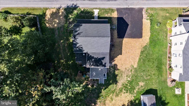 an aerial view of a house with garden space and a lake view