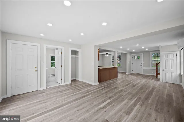 a view of an empty room with wooden floor
